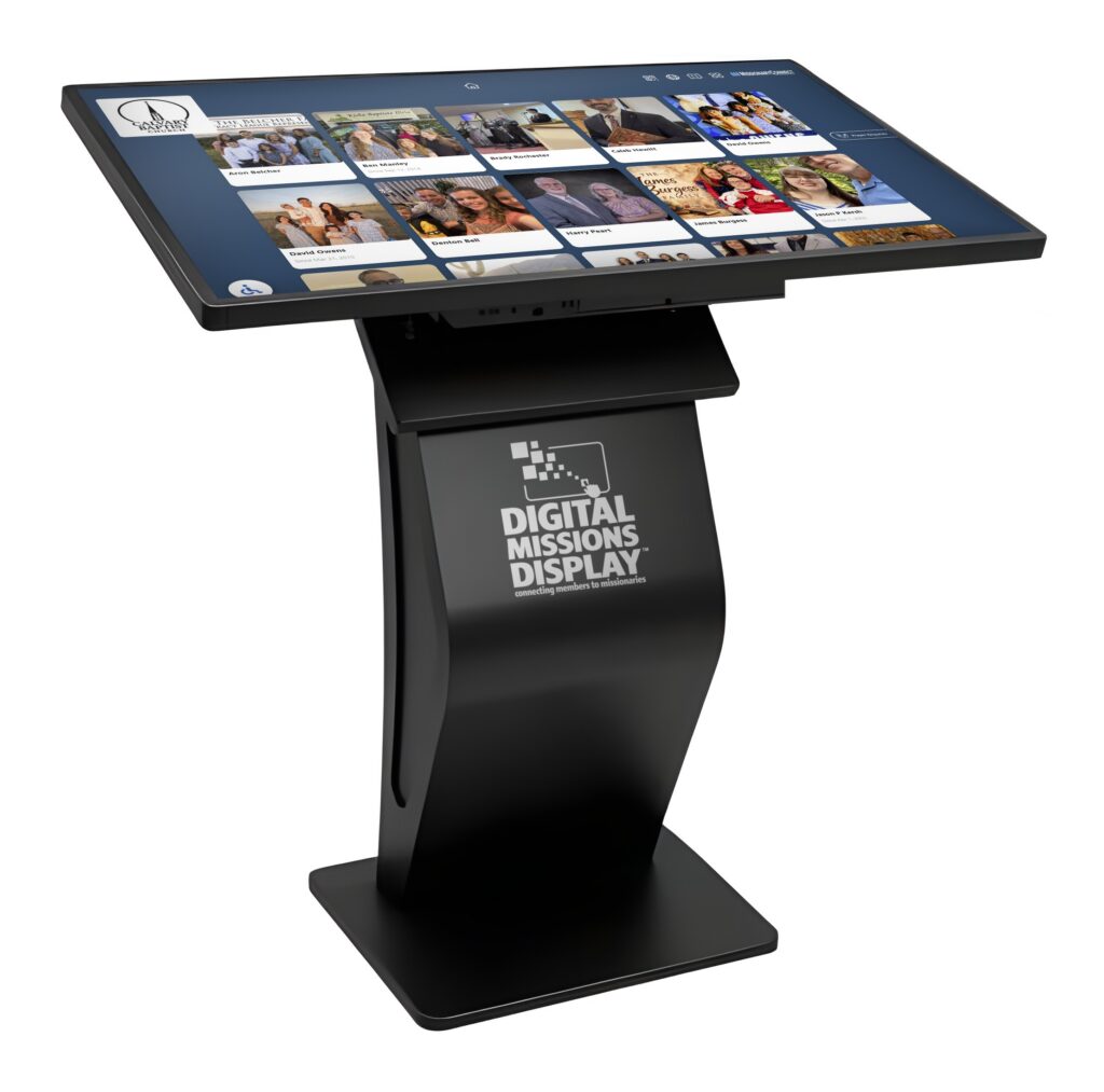 32-inch Digital Missions Display pedestal kiosk showing the MissionaryConnect Grid View of missionary family cards